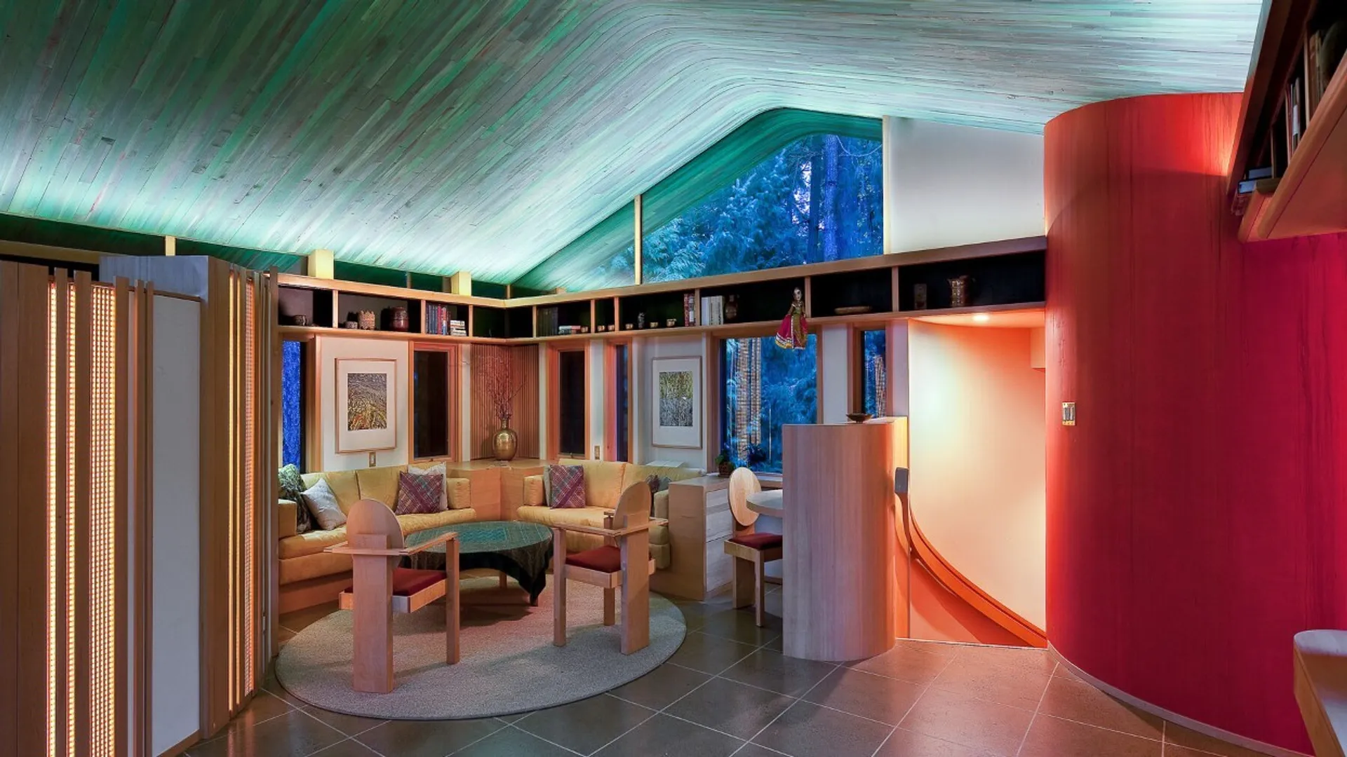 Interior of the Hunter Residence — the vaulted wood-paneled great room with library and hearth.